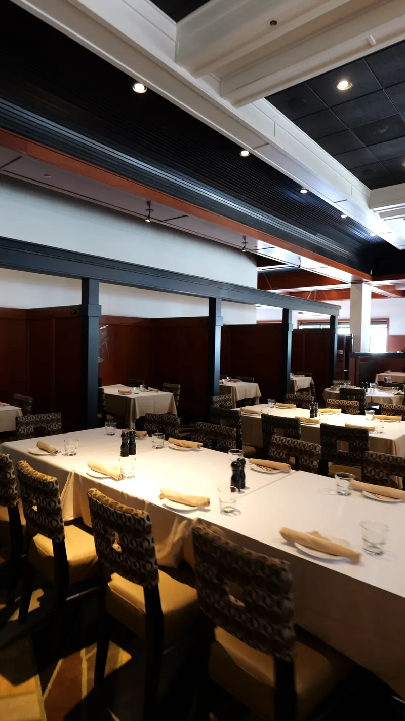 The dining room at Club Oceano, set with white linens