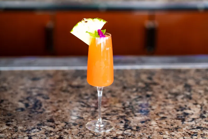An Island Oasis cocktail with pineapple at the bar