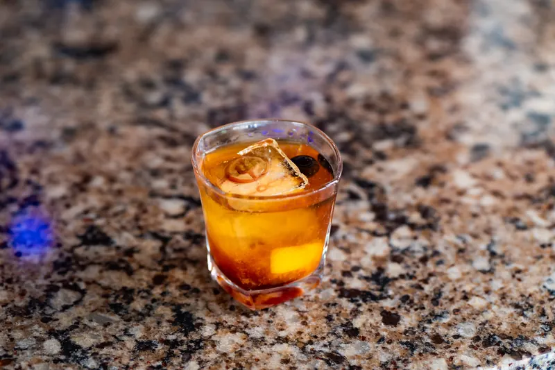 A smoked old fashioned on the bar